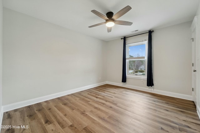 unfurnished room featuring visible vents, baseboards, light wood-style floors, and ceiling fan