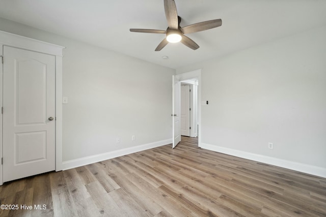 unfurnished bedroom featuring a ceiling fan, baseboards, and wood finished floors