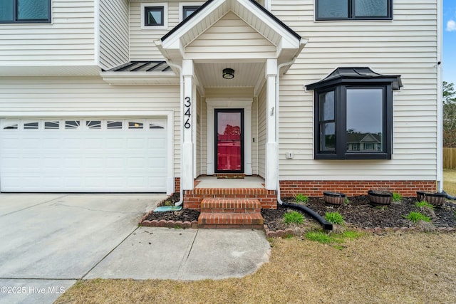 property entrance with a garage and driveway