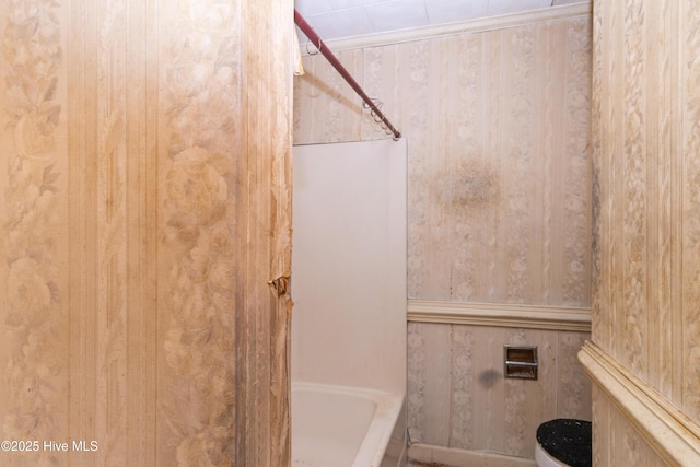 bathroom with toilet, a shower, and a washtub