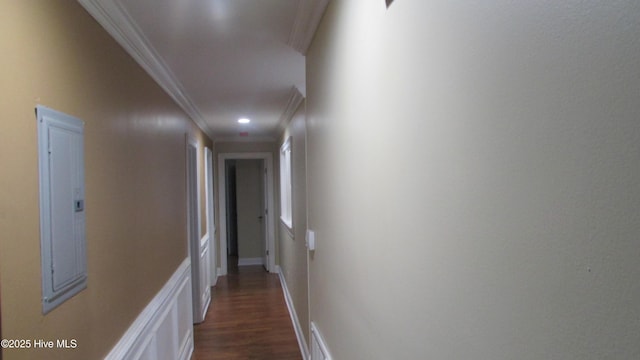 corridor featuring visible vents, baseboards, dark wood finished floors, electric panel, and ornamental molding