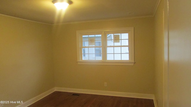 unfurnished room with baseboards, dark wood finished floors, and ornamental molding