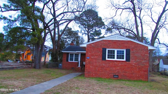 bungalow featuring crawl space, a chimney, a front yard, and brick siding