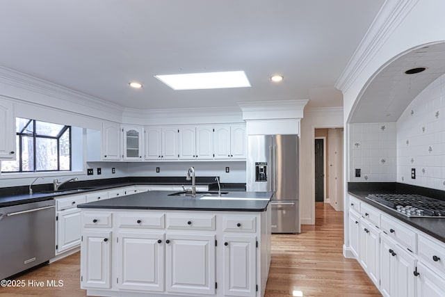 240 Donald Ross Dr, Pinehurst, NC 28374 - kitchen featuring appliances with stainless steel finishes, a sink, dark countertops, white cabinets, and ornamental molding