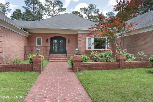 240 Donald Ross Dr, Pinehurst, NC 28374 - property entrance with french doors, a yard, brick siding, and a shingled roof