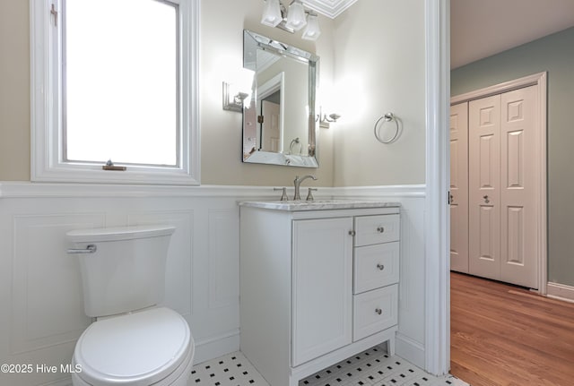 240 Donald Ross Dr, Pinehurst, NC 28374 - bathroom featuring a decorative wall, a wainscoted wall, toilet, vanity, and wood finished floors