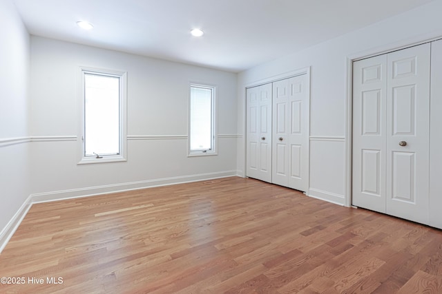 240 Donald Ross Dr, Pinehurst, NC 28374 - unfurnished bedroom with light wood-type flooring, baseboards, two closets, and recessed lighting