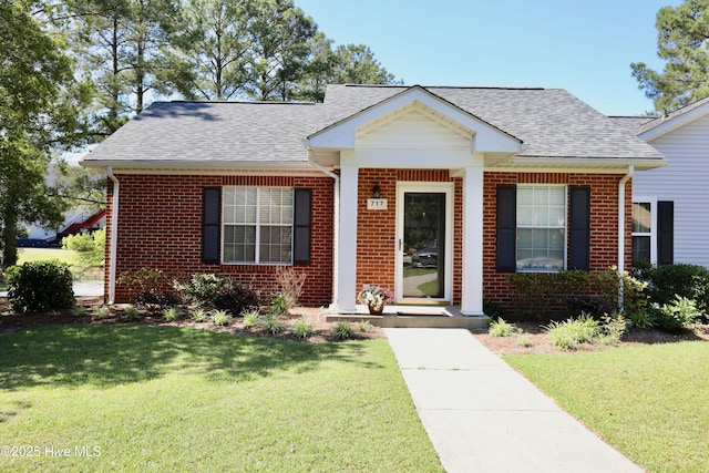 717 Chancery Ln, Aberdeen, NC 28315 - view of front of property with brick siding, roof with shingles, and a front yard