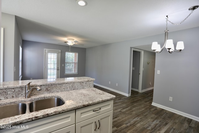 717 Chancery Ln, Aberdeen, NC 28315 - kitchen featuring a sink, a chandelier, baseboards, and dark wood-type flooring