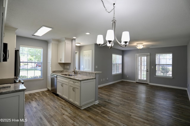 717 Chancery Ln, Aberdeen, NC 28315 - kitchen featuring appliances with stainless steel finishes, a peninsula, white cabinetry, dark wood-type flooring, and a chandelier