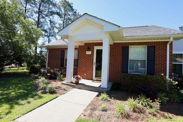 717 Chancery Ln, Aberdeen, NC 28315 - view of front of house featuring brick siding, roof with shingles, and a front lawn
