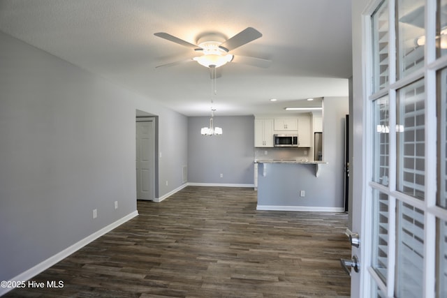 717 Chancery Ln, Aberdeen, NC 28315 - unfurnished living room featuring a ceiling fan, a chandelier, dark wood-style floors, baseboards, and recessed lighting