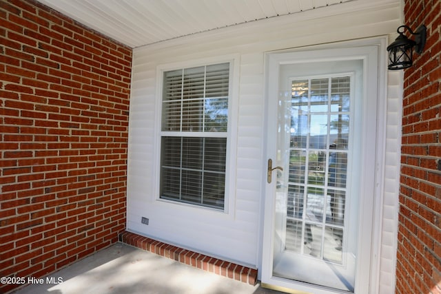 717 Chancery Ln, Aberdeen, NC 28315 - doorway to property featuring brick siding and covered porch