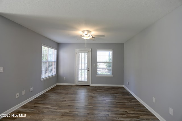 717 Chancery Ln, Aberdeen, NC 28315 - empty room with plenty of natural light, a ceiling fan, dark wood finished floors, baseboards, and a textured ceiling