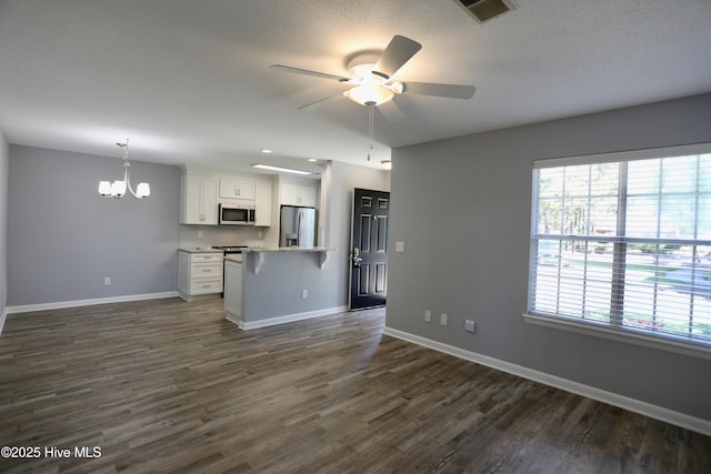 717 Chancery Ln, Aberdeen, NC 28315 - kitchen featuring stainless steel appliances, open floor plan, healthy amount of natural light, baseboards, and a textured ceiling