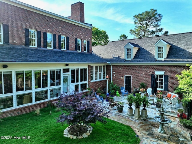 6680 Beulah Hill Church Rd, West End, NC 27376 - back of house with a patio area, a chimney, brick siding, and a lawn