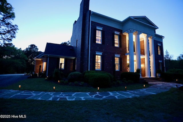 6680 Beulah Hill Church Rd, West End, NC 27376 - view of front of home featuring a front yard, brick siding, and a chimney