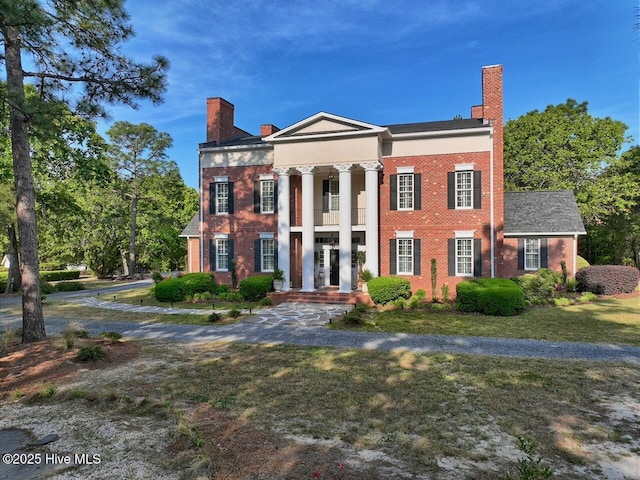6680 Beulah Hill Church Rd, West End, NC 27376 - greek revival house featuring a chimney, brick siding, and a front lawn