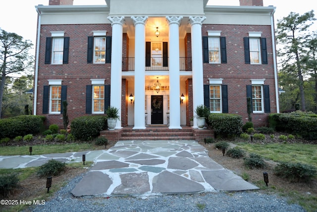 6680 Beulah Hill Church Rd, West End, NC 27376 - greek revival inspired property with a balcony, a chimney, and brick siding