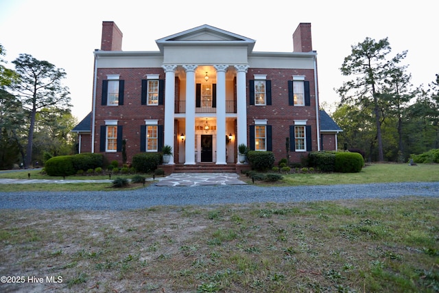6680 Beulah Hill Church Rd, West End, NC 27376 - neoclassical home featuring a chimney, a balcony, brick siding, and a front lawn