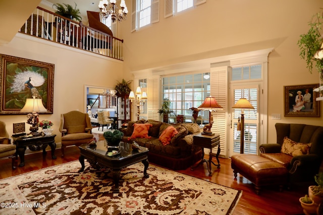 6680 Beulah Hill Church Rd, West End, NC 27376 - living room featuring wood finished floors, a chandelier, and a towering ceiling