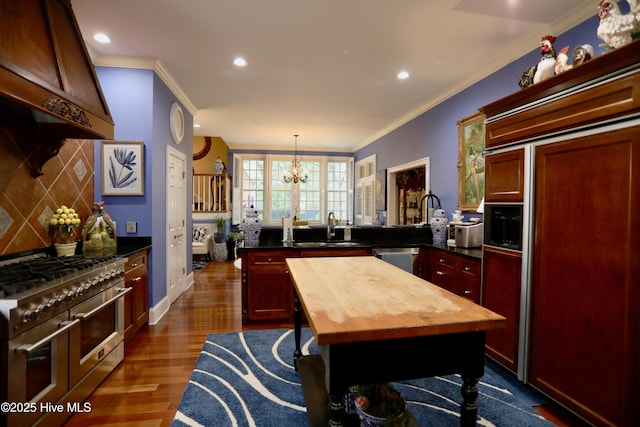 6680 Beulah Hill Church Rd, West End, NC 27376 - kitchen featuring high quality appliances, wood counters, custom range hood, a chandelier, and reddish brown cabinets