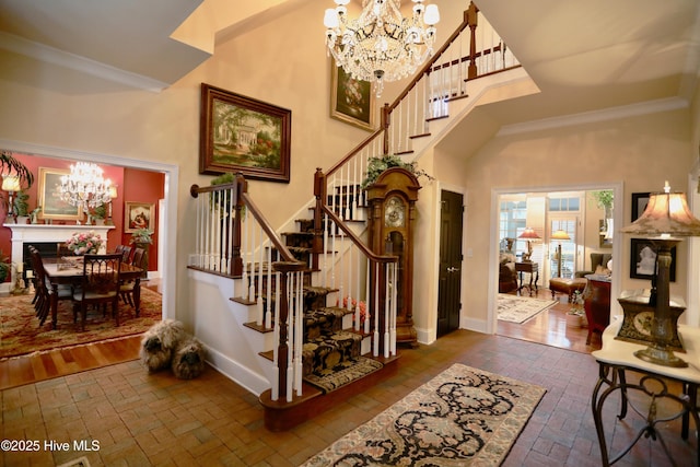 6680 Beulah Hill Church Rd, West End, NC 27376 - entryway featuring a chandelier, brick floors, stairs, and ornamental molding