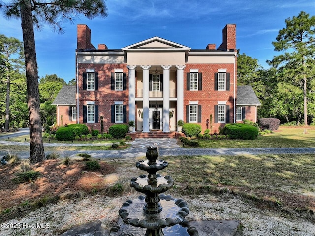 6680 Beulah Hill Church Rd, West End, NC 27376 - greek revival house with a chimney, a balcony, brick siding, and a front lawn