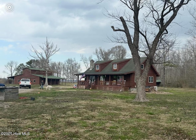 view of front of home featuring covered porch, a chimney, a front lawn, and dirt driveway