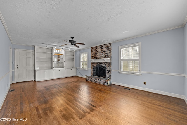 unfurnished living room featuring ceiling fan, a textured ceiling, wood finished floors, and crown molding