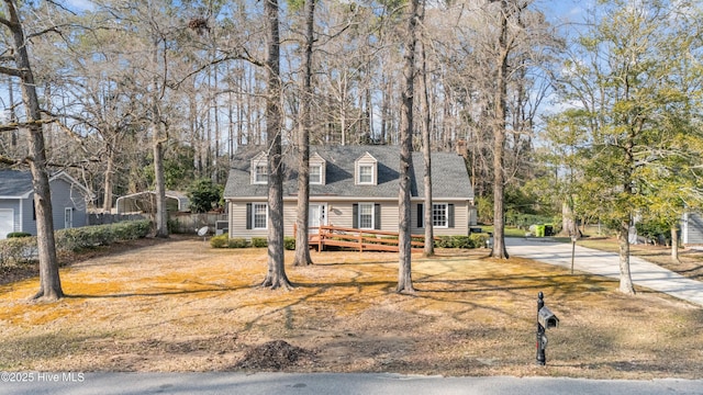 cape cod-style house with a deck