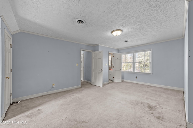 unfurnished bedroom with visible vents, baseboards, crown molding, and carpet