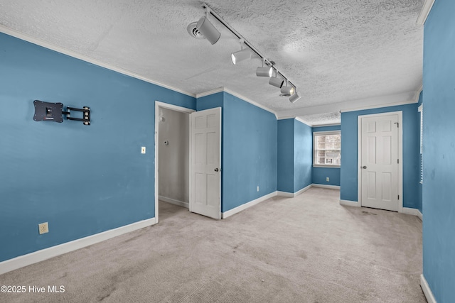 additional living space featuring a textured ceiling, baseboards, and carpet floors