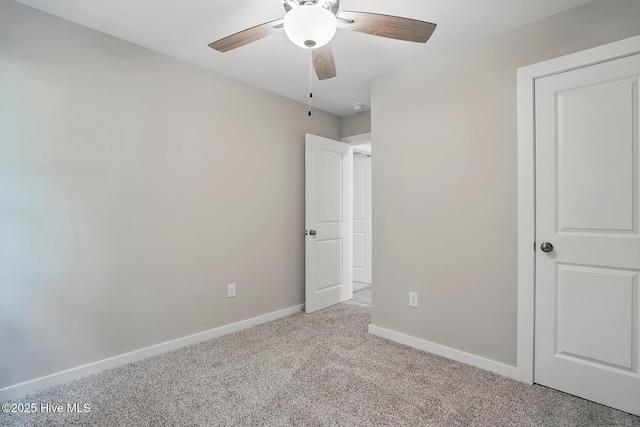 unfurnished bedroom featuring carpet, baseboards, and a ceiling fan