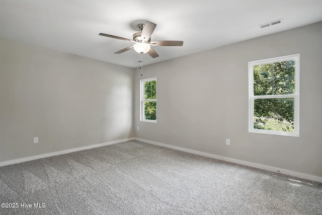 unfurnished room with a ceiling fan, baseboards, and carpet floors