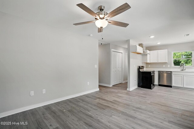 kitchen featuring stainless steel dishwasher, range with electric cooktop, ceiling fan, baseboards, and white cabinetry