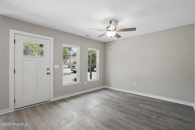 entrance foyer featuring ceiling fan, wood finished floors, and baseboards