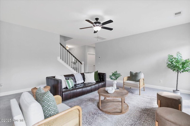 living room with visible vents, baseboards, stairs, and a ceiling fan