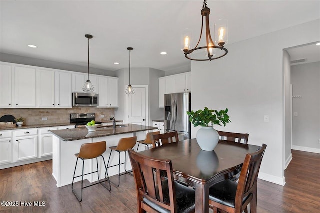 dining space featuring visible vents, dark wood finished floors, recessed lighting, baseboards, and a chandelier