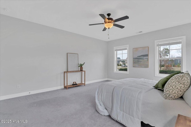 carpeted bedroom with baseboards, visible vents, and ceiling fan