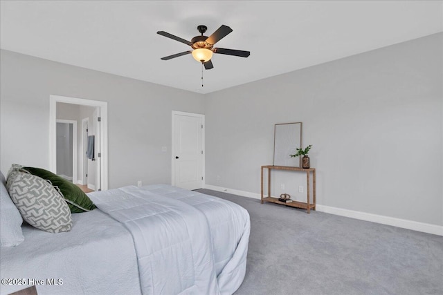 carpeted bedroom featuring baseboards and a ceiling fan