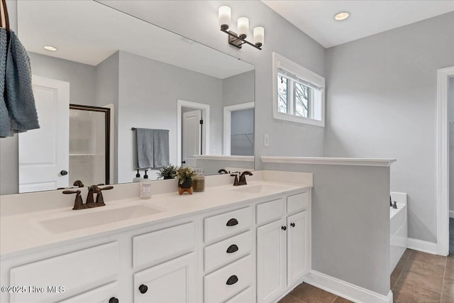 bathroom with double vanity, a shower with shower door, a bath, and a sink