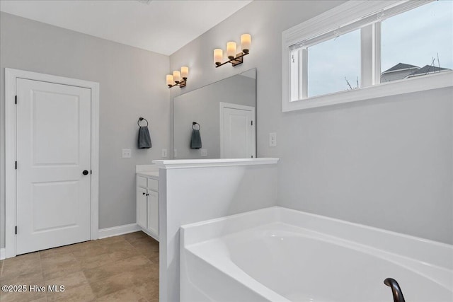 bathroom featuring vanity and a bath