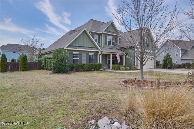 craftsman-style home with a garage, board and batten siding, a front yard, and fence
