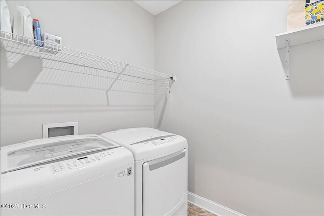 laundry area with laundry area, baseboards, and separate washer and dryer