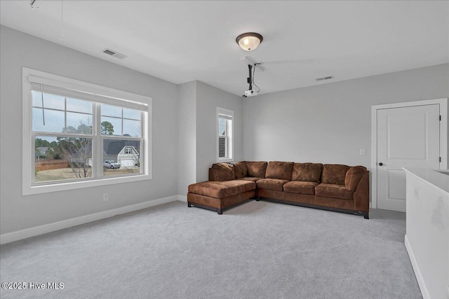 living area featuring carpet, visible vents, and baseboards