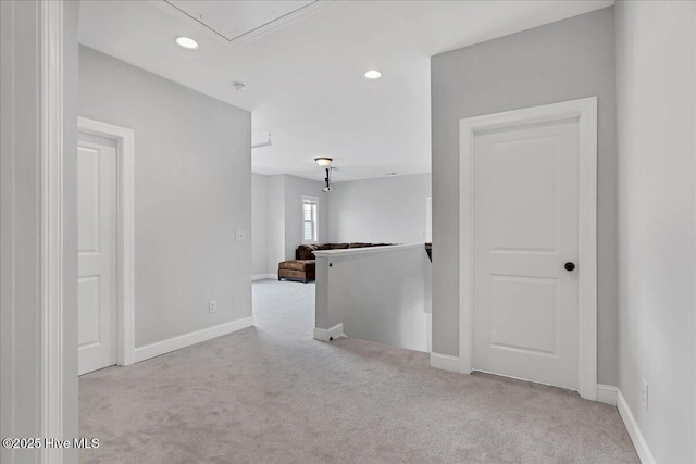 carpeted spare room featuring recessed lighting, baseboards, and attic access