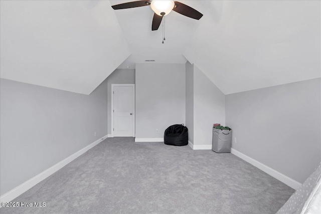 bonus room featuring a ceiling fan, visible vents, carpet floors, baseboards, and vaulted ceiling