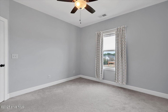 empty room featuring baseboards, carpet, visible vents, and ceiling fan