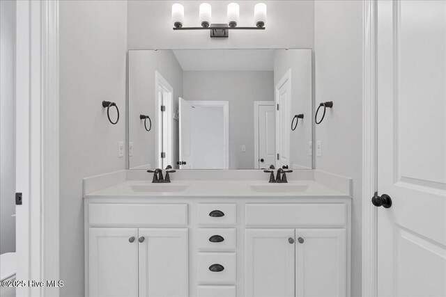 bathroom with double vanity and a sink